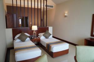 Letto o letti in una camera di Sooriya Resort & Spa