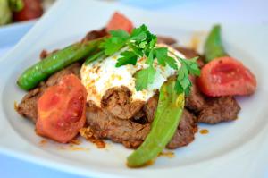 a plate of food with a piece of meat and vegetables at Lugga Boutique Hotel & Beach in Ortakent