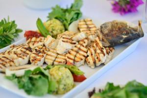 a white plate of food with meat and vegetables at Lugga Boutique Hotel & Beach in Ortakent