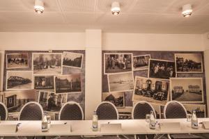 a room with tables and pictures on the wall at Haparanda Stadshotell in Haparanda