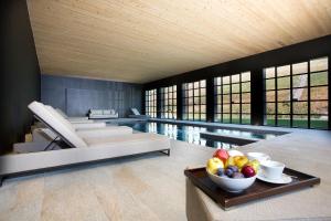 a swimming pool with a bowl of fruit on a table at Réva Resort in Monforte dʼAlba