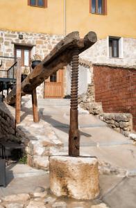 a stone wall with a wooden pole on top of it at aCienLeguas in Castrojeriz