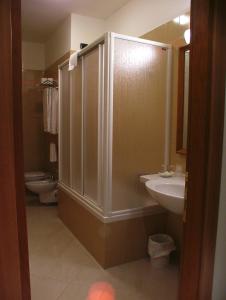 a bathroom with a shower and a sink and a toilet at Hotel Centro di Spiritualità Padre Pio in San Giovanni Rotondo