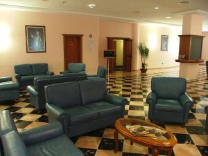 a waiting room with couches and chairs and a table at Hotel Centro di Spiritualità Padre Pio in San Giovanni Rotondo