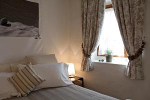 a hotel room with two beds and a window at Maison Bondaz & SPA privé in Aosta