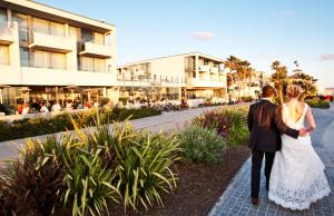 a bride and groom walking down a street at Tower 23 Hotel in San Diego