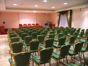 a room with rows of chairs and a podium at Hotel Centro di Spiritualità Padre Pio in San Giovanni Rotondo