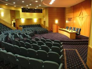 an auditorium with chairs and a podium in the middle at Hotel Centro di Spiritualità Padre Pio in San Giovanni Rotondo