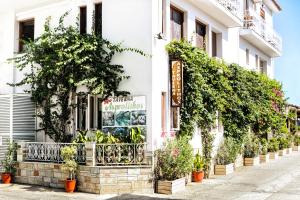 a building with plants in front of it at Asprolithos Studios in Skiathos