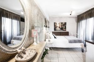 a bedroom with a large mirror and a bed at Asprolithos Studios in Skiathos