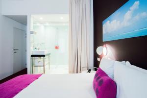 a bedroom with a large bed and a bathroom at Smartflats - Pacific Brussels in Brussels