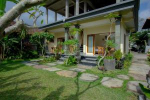 a house with a garden in front of it at Yudha Ubud in Ubud