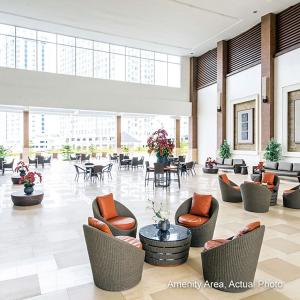 a lobby with chairs and tables in a building at Wind Residences by Bea and RM in Tagaytay