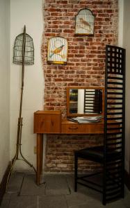 a wooden desk with a lamp and a lamp post at Posada del León de Oro Boutique Hotel in Madrid