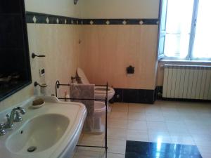 a bathroom with a white sink and a toilet at B&B Villa Gualterio in Bolsena +30 photos