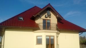 a white house with a red roof at Noclegi Darex in Pyrzowice