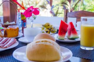 a table topped with plates of food and fruit at Pousada Barros in Jericoacoara +34 photos