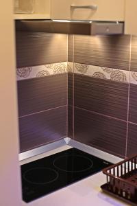 a kitchen with brown blinds on the wall at Apartman Vanja in Bar