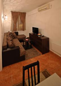 a living room with a couch and a television at Apartman Vanja in Bar