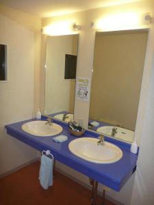 a bathroom with two sinks and a large mirror at K's House Hakuba Alps - Travelers Hostel in Hakuba
