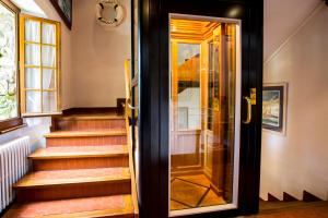 an open door to a house with stairs at Hôtel Restaurant Du Port in Yvoire