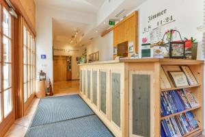 a hallway with bookshelves and a book shelf at Landgasthof - Hotel Reindlschmiede in Bad Heilbrunn