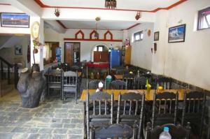 a room with tables and chairs in a restaurant at Shrestha Hotel & Restaurant in Bandipur