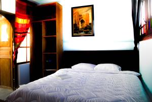a bedroom with a bed with two pillows at dar wassim el ghali in Rabat