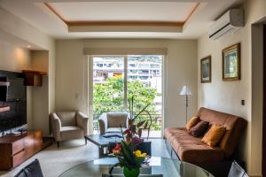 a living room with a couch and a glass table at V399 - 307 in Puerto Vallarta