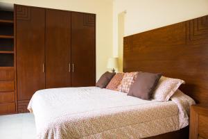 a bedroom with a large bed and wooden cabinets at V399 - 307 in Puerto Vallarta