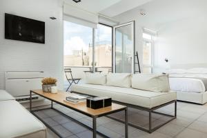 a living room with a couch and a bed and a table at Euryclea Residences in Athens