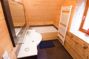 a bathroom with a shower and a sink and a tub at Chalet LEPERVIERE in Vaujany +19 photos