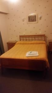 Una cama o camas en una habitación de Palace Hotel