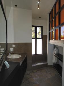 a bathroom with a sink and a window at El Magnifico in Cabarete