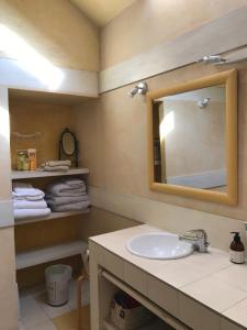a bathroom with a sink and a mirror and towels at Gite de la Girafe in Féricy +17 photos