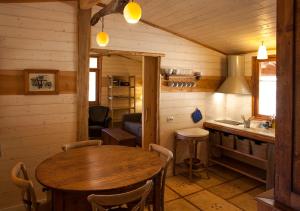 a kitchen with a wooden table in a room at Masía El Moli de Can Aulet in Arbúcies