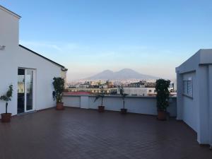 a balcony with potted plants and a view of a city at "Panoramic Terrazza - Napoli" in Naples