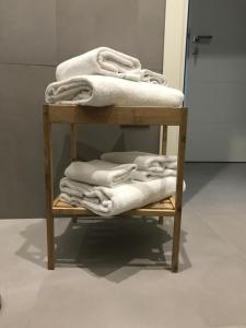a pile of towels on a shelf in a bathroom at "Panoramic Terrazza - Napoli" in Naples +53 photos