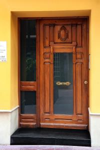 a wooden door on a yellow building at Laila Home in Barbastro