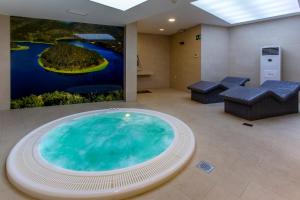 a living room with a pool and a large screen tv at Hospederia Hurdes Reales in Las Mestas