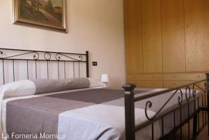 een slaapkamer met 2 bedden en een dressoir bij laforneriamornico in Mornico Losana