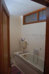 a bathroom with a bath tub and a toilet at Rosa dei venti in Lavarone +36 photos