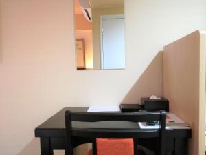 a desk in a room with a mirror on the wall at Kyoto Inn Gion The Second in Kyoto