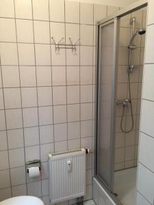 a bathroom with a shower and a radiator at Ferienwohnungen Plauen in Plauen