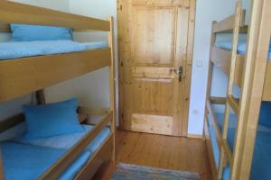 a room with three bunk beds and a door at Ferienwohnung Ebner in Flattach