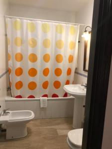 a bathroom with a polka dot shower curtain and a sink at Hotel Las Rosas in Priego de Córdoba