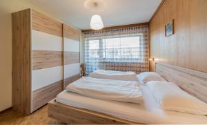 a bedroom with a large bed and a window at Residence Trametsch in Bressanone