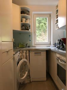 a kitchen with a washing machine and a window at Apartment Gisi in Innsbruck