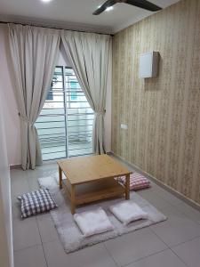 a living room with a wooden table and a window at Sitiawan Homestay Entire Semi D home in Sitiawan