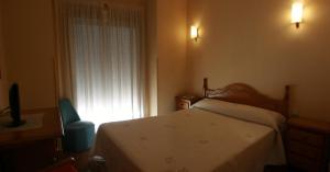 Postel nebo postele na pokoji v ubytování Hostal Sunami